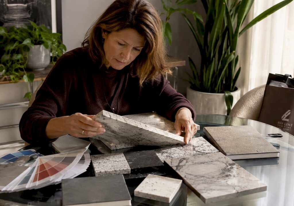 Architect comparing natural and engineered stone slabs