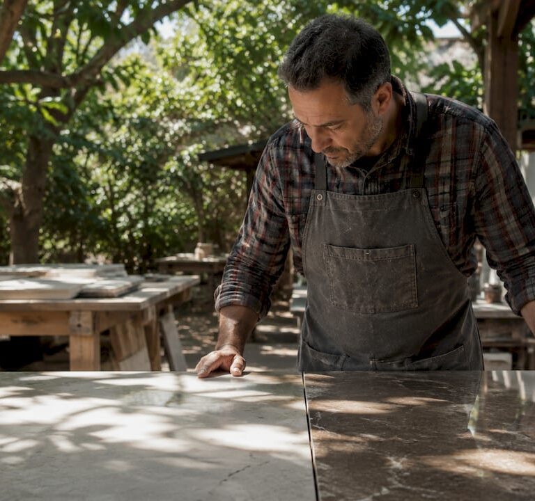Stone fabricator comparing honed and polished surfaces