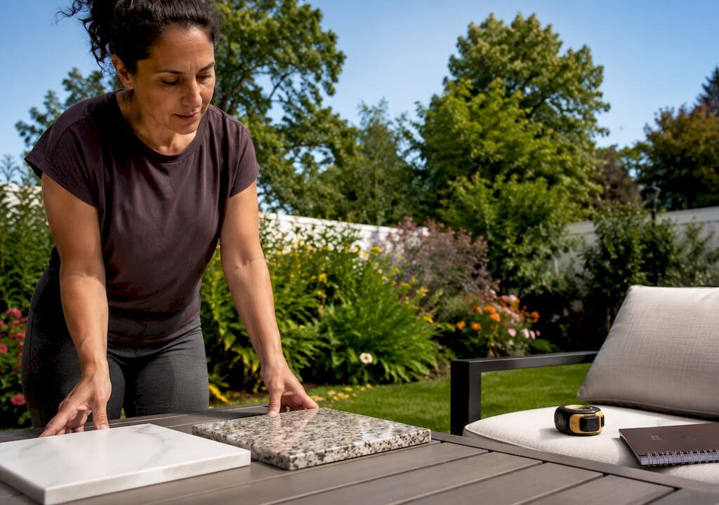 Homeowner comparing quartz and granite countertops