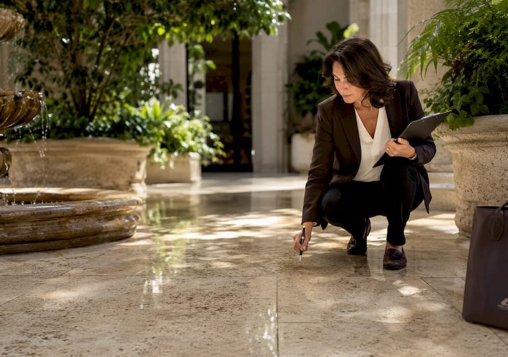 Property manager inspecting marble lobby floor